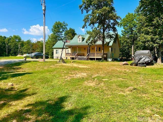 1334 Sutterfield Rd, Fox, AR 72051 - rear view of property with covered porch and a yard