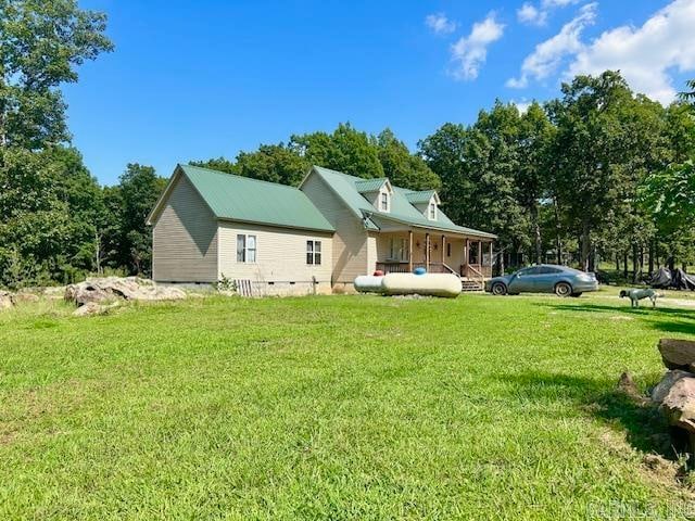 back of property featuring a lawn