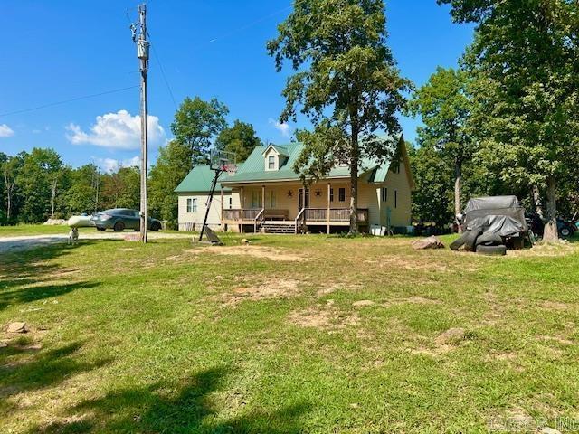 1334 Sutterfield Rd, Fox, AR 72051 - back of property with covered porch and a lawn