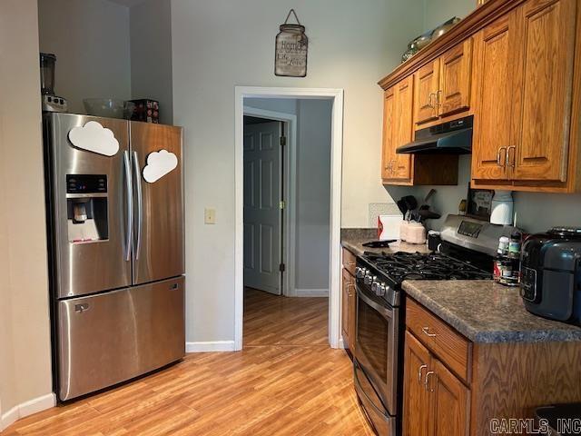 1334 Sutterfield Rd, Fox, AR 72051 - kitchen with appliances with stainless steel finishes, under cabinet range hood, brown cabinetry, and dark countertops