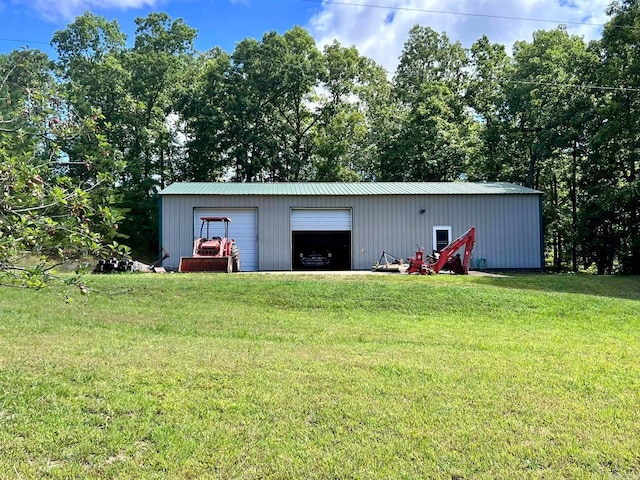 view of outbuilding with a garage and a lawn