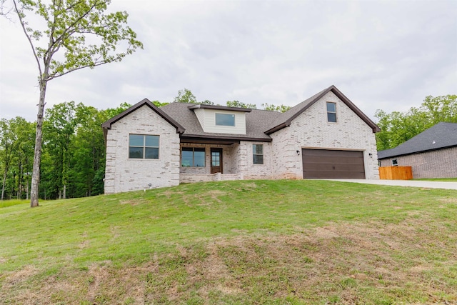 view of front of home with a garage and a front lawn