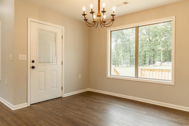 9 Jeremiah Cv, Heber Springs, AR 72543 - unfurnished room featuring a healthy amount of sunlight, dark hardwood / wood-style floors, and a chandelier