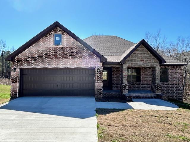 view of front of home with a garage and a front lawn