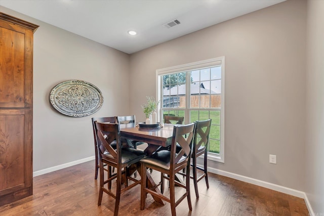 dining area featuring dark wood-type flooring