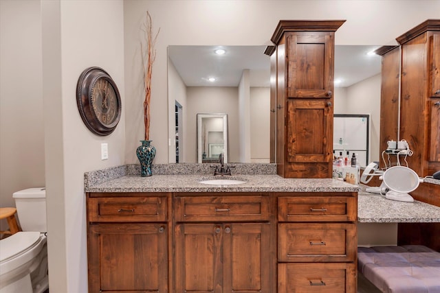 bathroom featuring vanity and toilet