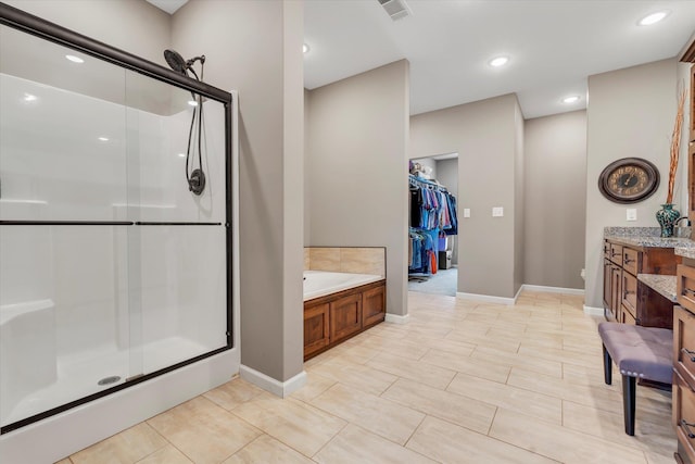 bathroom featuring vanity and separate shower and tub