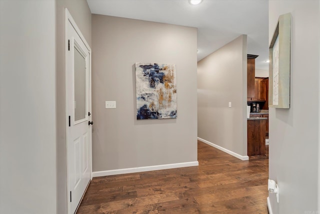 hallway with dark hardwood / wood-style flooring