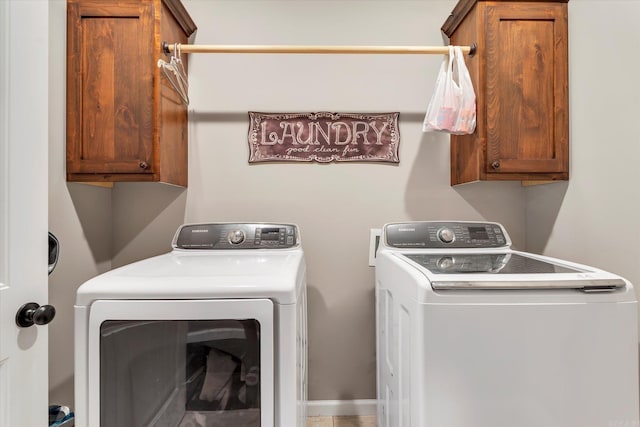 washroom with cabinets and washer and clothes dryer