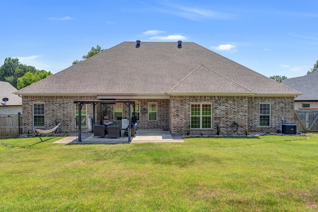 rear view of property featuring a patio, central AC unit, and a lawn