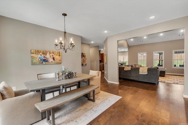 dining area featuring a notable chandelier and dark wood-type flooring