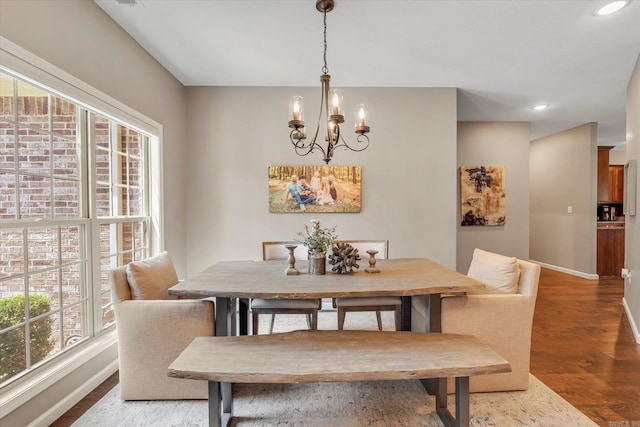 dining area with a notable chandelier and wood-type flooring