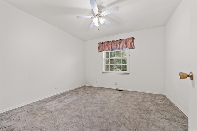 spare room with ceiling fan and carpet