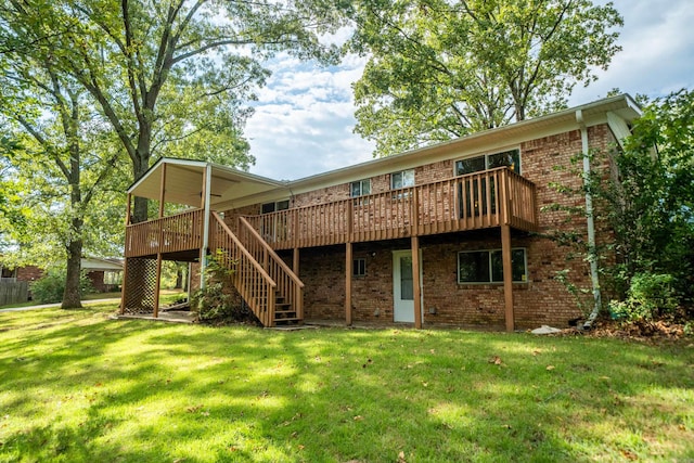 rear view of property with a wooden deck and a yard