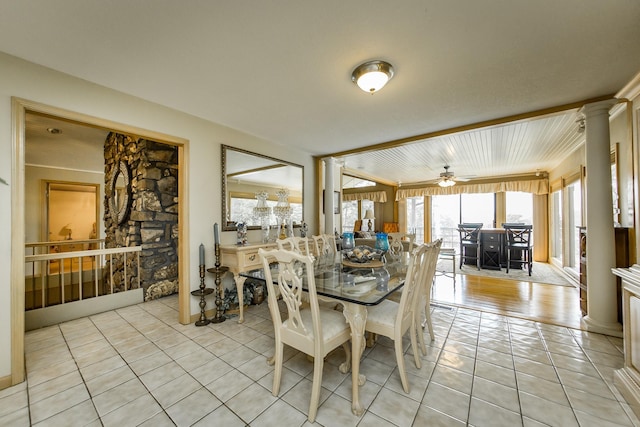 dining area with light tile patterned floors and ornate columns