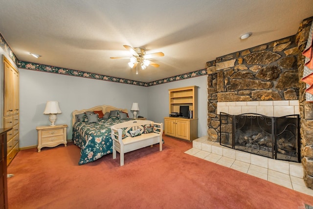 bedroom featuring ceiling fan, carpet, a textured ceiling, and a fireplace