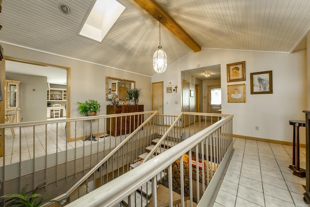 hall with light tile patterned flooring, vaulted ceiling with skylight, and wooden ceiling