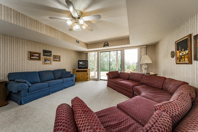 living room featuring ceiling fan and carpet