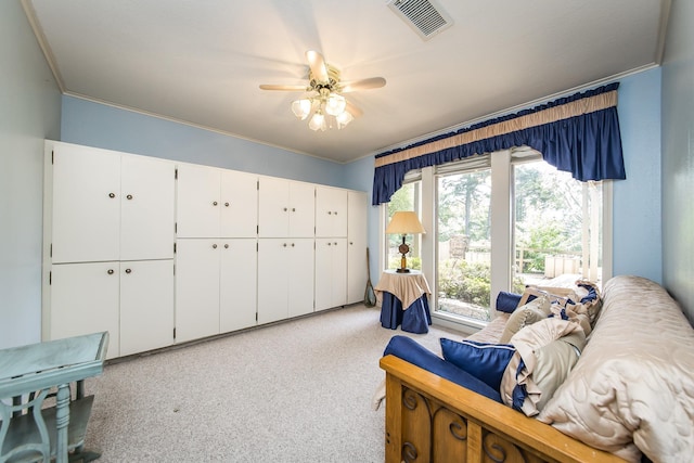 living area with ornamental molding and ceiling fan