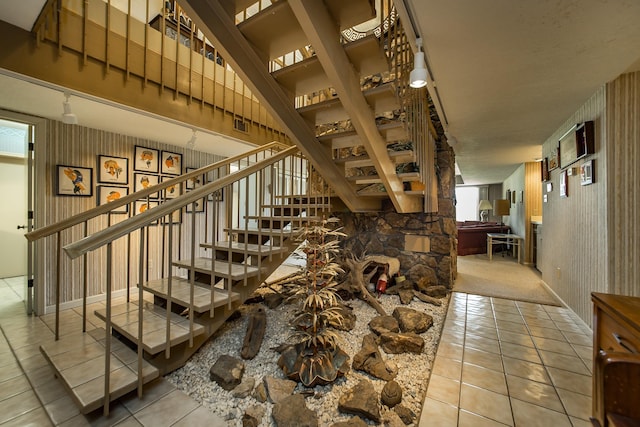 stairs featuring tile patterned flooring