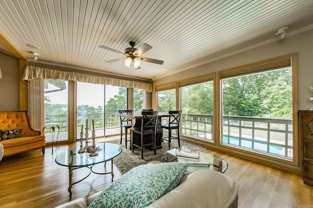 sunroom / solarium with wooden ceiling and ceiling fan