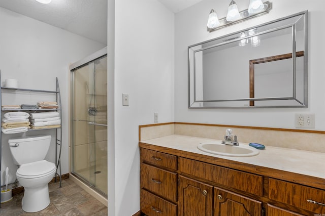 bathroom with walk in shower, tile patterned floors, toilet, and vanity