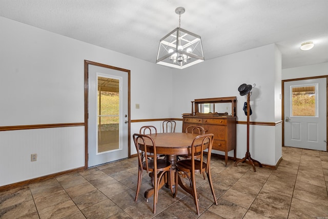 dining room featuring an inviting chandelier and tile patterned flooring