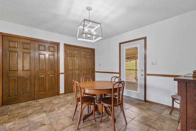 dining room with a notable chandelier and light tile patterned floors