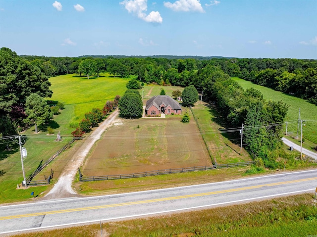 drone / aerial view featuring a rural view and a view of trees