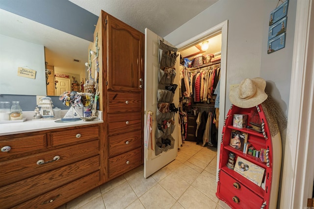 spacious closet featuring light tile patterned floors