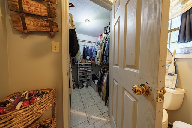 spacious closet featuring light tile patterned flooring