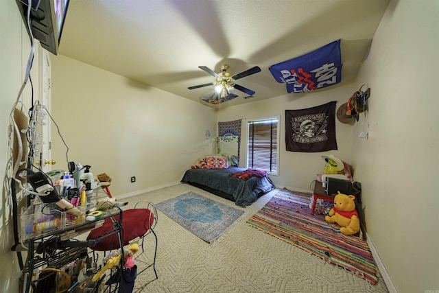 carpeted bedroom with a ceiling fan and baseboards