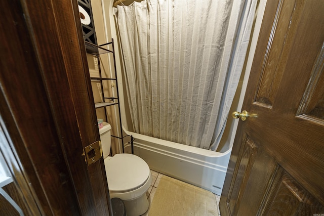 full bath featuring shower / tub combo, wood finished floors, and toilet