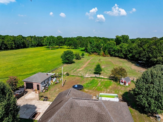 birds eye view of property with a view of trees and a rural view