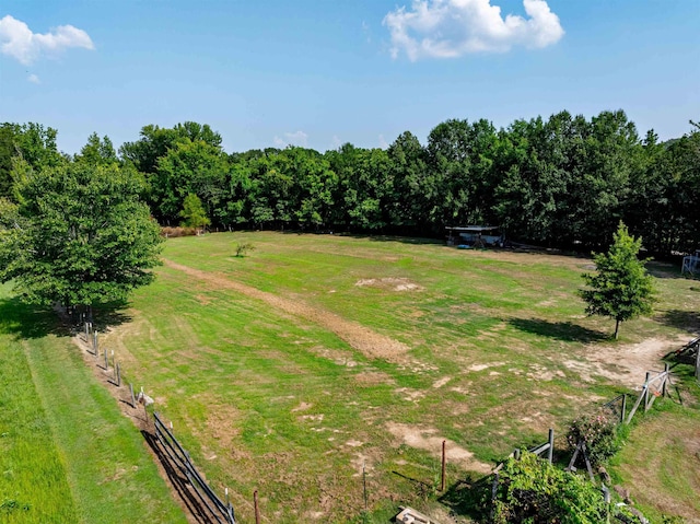 view of yard featuring fence and a rural view