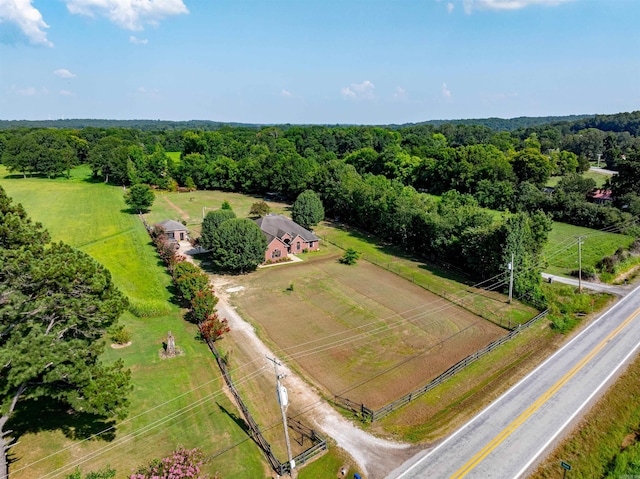 drone / aerial view featuring a rural view and a view of trees