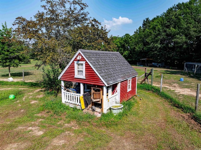 view of outbuilding with an outbuilding and fence