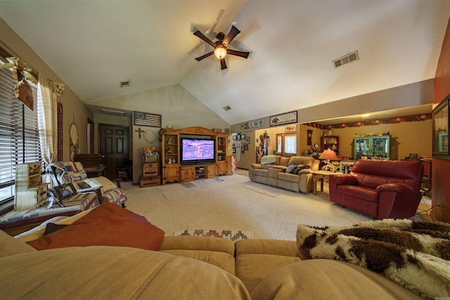 carpeted living area featuring a ceiling fan, visible vents, and high vaulted ceiling