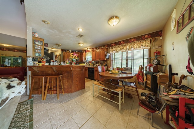 dining space featuring visible vents, a textured ceiling, and light tile patterned floors