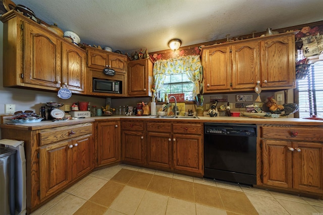 kitchen with black appliances, a sink, light countertops, and brown cabinets