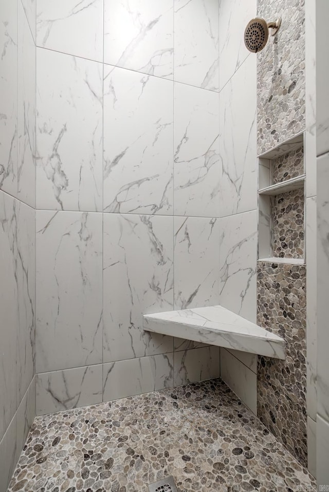 bathroom with tiled shower