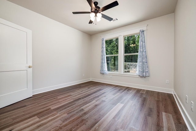 empty room featuring dark hardwood / wood-style floors and ceiling fan