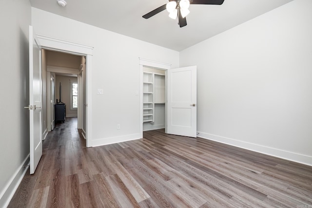 unfurnished bedroom with a closet, hardwood / wood-style floors, and ceiling fan