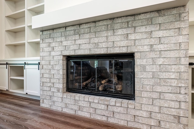 details with a brick fireplace and hardwood / wood-style floors