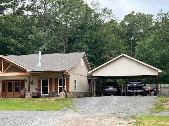 view of front of property with a carport, a porch, and a front yard