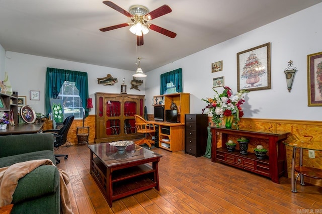 living room featuring wood-type flooring and ceiling fan