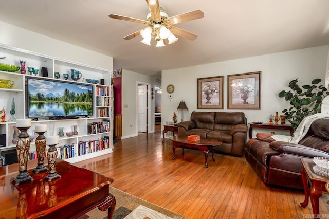 living room featuring ceiling fan and hardwood / wood-style flooring