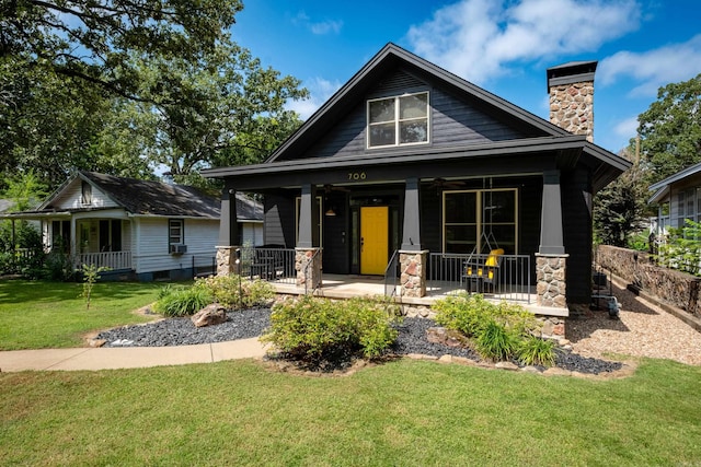 view of front of house featuring a porch and a front yard