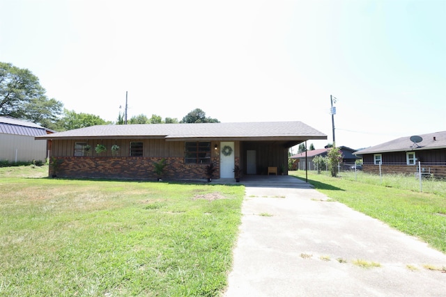 ranch-style house with a carport and a front lawn