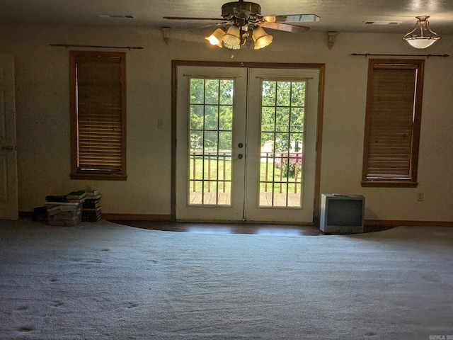 doorway to outside featuring carpet, french doors, and ceiling fan